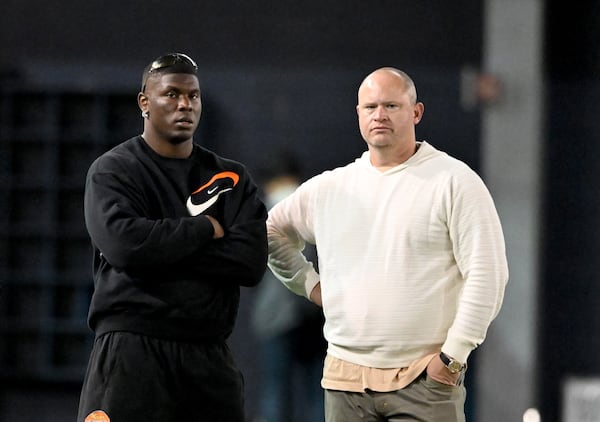 Georgia Tech head coach Brent Key (right) and former Georgia Tech defensive lineman Keion White (left) watch during Georgia Tech Pro Day at Rose Bowl Field and the Mary and John Brock Football Practice Facility, Friday, March 14, 2025, in Atlanta. (Hyosub Shin / AJC)