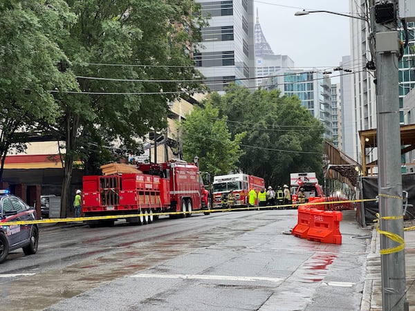 Police and fire crews are seen in Midtown following a partial crane collapse Monday afternoon.