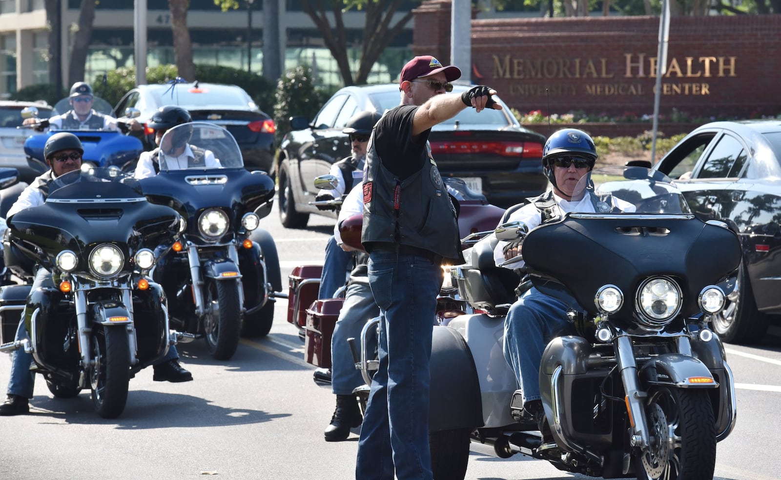 Greg “LT” Ernst (standing), a leader with the Patriot Guard Riders, directs participants before the May 18 funeral service for Kelvin Ansari, a Savannah police officer and an Army veteran, at Calvary Baptist Temple in Savannah. Perhaps 40 motorcycle-riding members of the guard attended. HYOSUB SHIN / HSHIN@AJC.COM