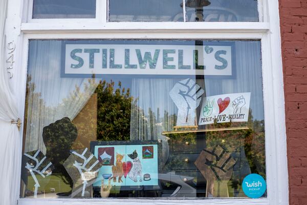 The storefront of Stillwell's Emporium displays racial justice solidarity signs in the downtown Stone Mountain. (ALYSSA POINTER / ALYSSA.POINTER@AJC.COM)