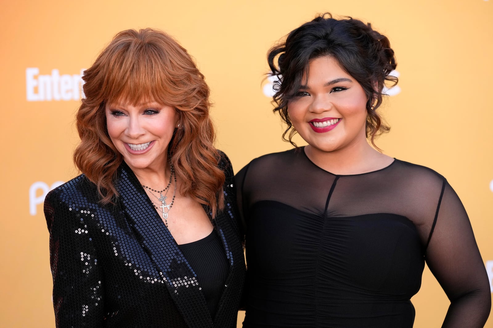 Reba McEntire, left, and Belissa Escobedo, cast members in the television series "Happy's Place," pose together at the NBC Fall Comedy Celebration, Wednesday, Oct. 9, 2024, in Los Angeles. (AP Photo/Chris Pizzello)