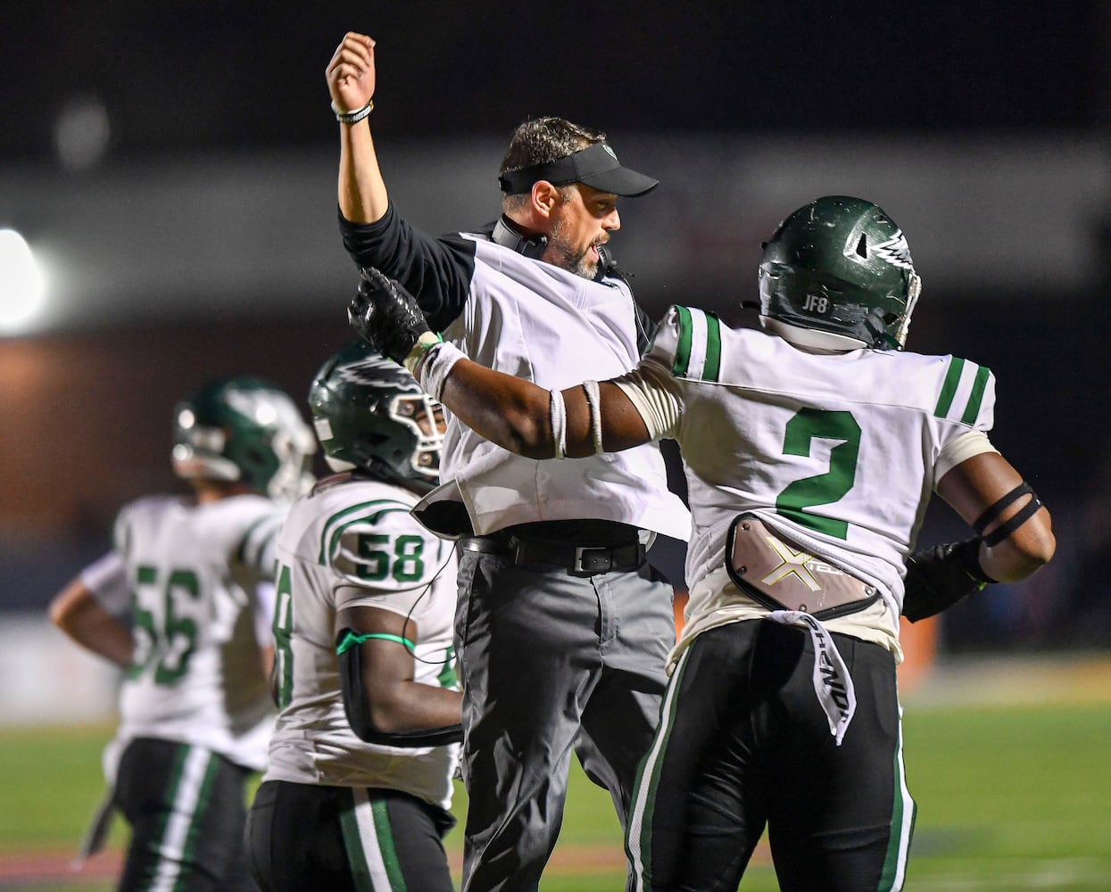 Collins Hill head coach Drew Swick celebrates with Deuce Geralds (2) after scoring against North Cobb during the second half of play Friday, Nov. 10, 2023 at North Cobb High School. (Daniel Varnado/For the AJC)