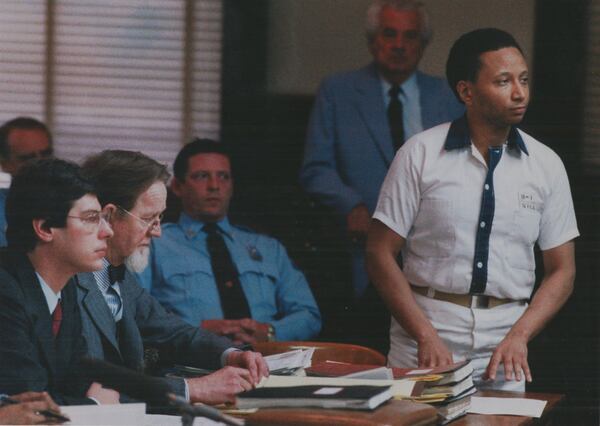 19860210 - JACKSON, GA — Wayne Williams stands before Superior Court judge Hal Craig in Butts County Superior Court. William’s defense attorneys (l-r) Ron Kuby, Bobby Lee Cook, Jackson Diagnostic Center officer Neil Earnhart, baliff W.N. Johnson (standing background). (STEVE DEAL/AJC staff) 1986