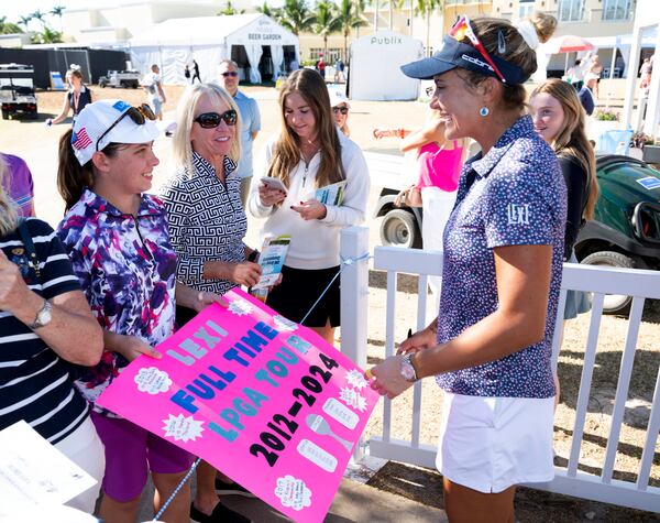 Lexi Thompson, right, gives autographs after her final round of play during the final round of the LPGA CME Group Tour Championship golf tournament Sunday, Nov. 24, 2024, in Naples, Fla. (AP Photo/Chris Tilley)