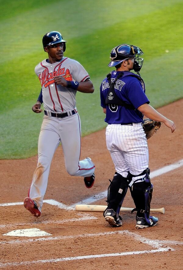 Atlanta Braves B.J. Upton, left, scores on a fielders choice hit by Evan Gattis as Colorado Rockies catcher Michael McKenry waits for the throw in the fourth inning of a baseball game on Monday, June 9, 2014, in Denver. (AP Photo/Chris Schneider) A sight seldom seen: B.J. Upton scores a run. (Chris Schneider/AP)