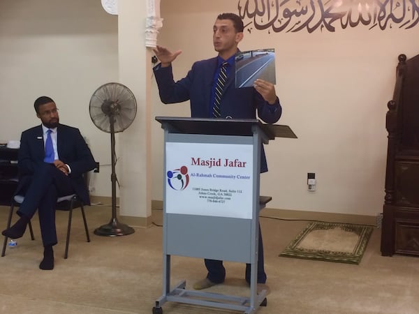 Ibrahim Awad (right), the lawyer representing a woman killed by Johns Creek police, and Edward Ahmed Mitchell, executive director of the Georgia chapter of the Council on American-Islamic Relations, discuss the incident at a community meeting Saturday. (Photo by Bill Torpy /AJC)