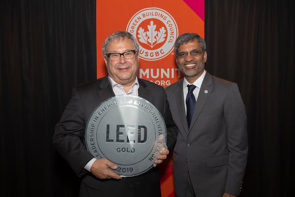 U.S. Green Building Council President Mahesh Ramanujam (right) presents Hawks and State Farm Arena CEO Steve Koonin with a plaque to honor the arena’s LEED Gold certification on Thursday, June 13, in Atlanta. 