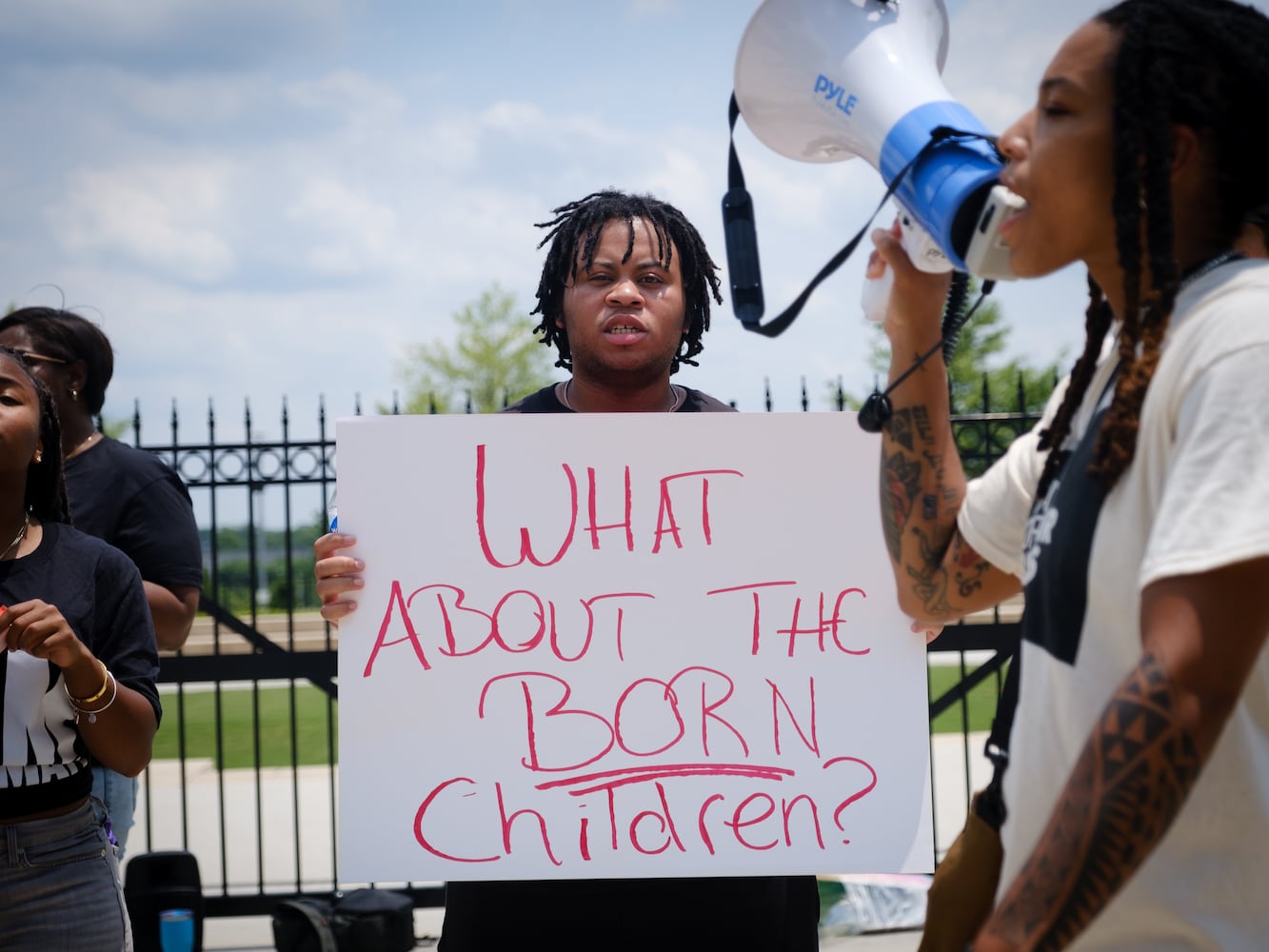 Kenneth Nellum (center) participates in an abortion rights rally organized by Georgia Stand Up in front of the Georgia State Capitol on Friday, June 24, 2022. The rally follows the Supreme Court ruling overturning Roe v. Wade. (Arvin Temkar / arvin.temkar@ajc.com)