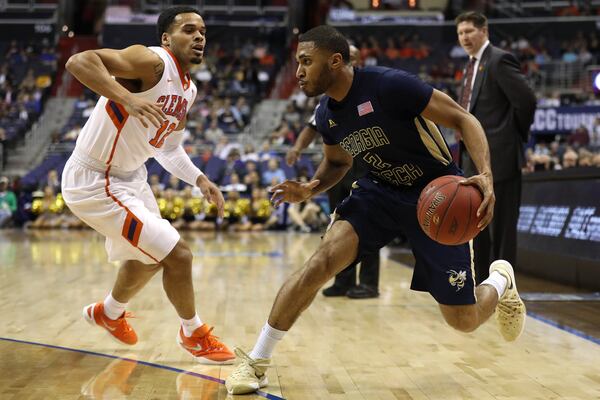 WASHINGTON, DC - MARCH 09: Adam Smith #2 of the Georgia Tech Yellow Jackets dribbles in front of Avry Holmes #12 of the Clemson Tigers during the first half in the second round of the 2016 ACC Basketball Tournament at Verizon Center on March 9, 2016 in Washington, DC.(Photo by Patrick Smith/Getty Images)