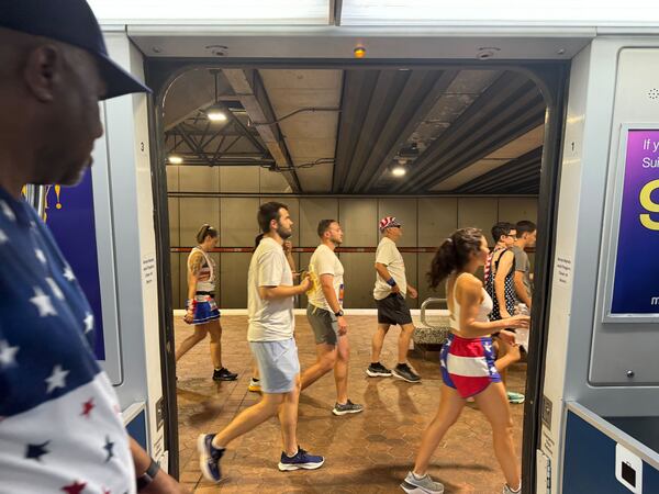 Runners take MARTA early Thursday morning to the AJC Peachtree Road Race. (Dawn Sawyer / AJC)