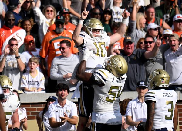 Georgia Tech quarterback Haynes King (10) celebrates with offensive lineman Jordan Williams during the Yellow Jackets' Nov. 9 upset of Miami.