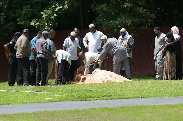 8/23/18 - Atlanta - Family of Abdul-ghani Wahhaj, including his grandfather Imam Siraj Wahhaj, right, bury him on Thursday, August 23. Jenna Eason / Jenna.Eason@coxinc.com