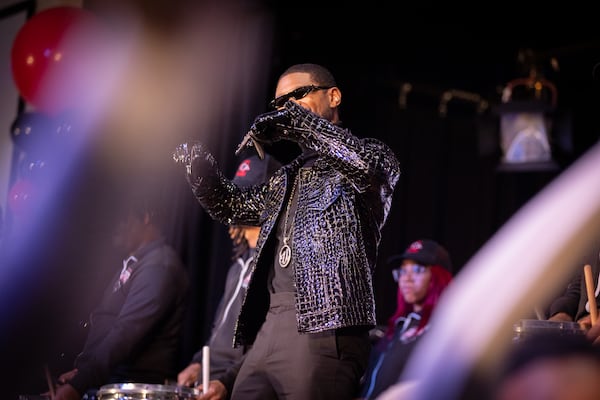 Usher appears for a homecoming rally at Clark Atlanta University in Atlanta on Wednesday, February 14, 2024, while the CAU marching band plays. Along with other honors, Amazon presented a $25,000 donation to Usher’s New Look Foundation. (Arvin Temkar / arvin.temkar@ajc.com)