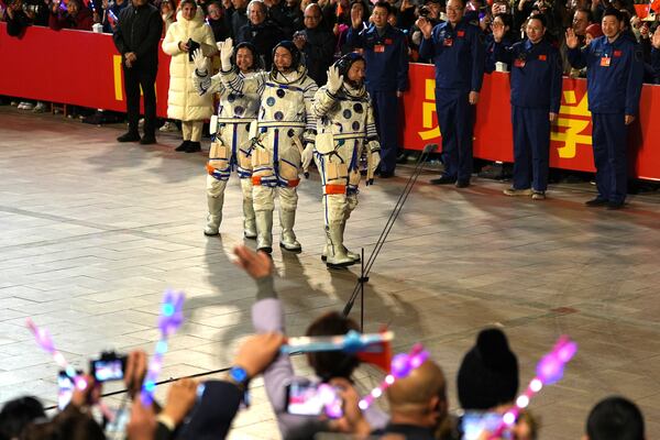 From left, Chinese astronauts Wang Haoze, Song Lingdong and Cai Xuzhe wave during the see-off ceremony for the Shenzhou-19 mission at the Jiuquan Satellite Launch Center in northwestern China in the early hours of Wednesday, Oct. 30, 2024. (AP Photo/Ng Han Guan)