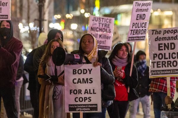 Shenita Binns (center) attends a protest on Friday, January 27, 2023, against the killing of Tyre Nichols in an incident with Memphis police. About 50 protesters gathered at Centennial Olympic Park in Atlanta. (Arvin Temkar / arvin.temkar@ajc.com)