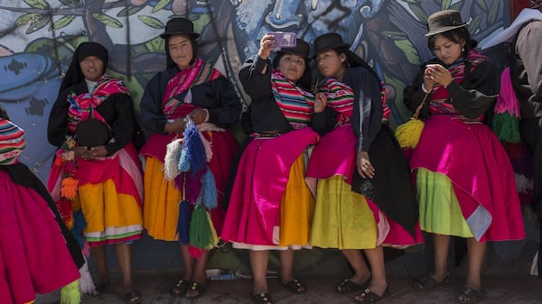 In this Jan. 29, 2017 photo, dancers take selfies after performing during Virgin of Candelaria celebrations in Puno, Peru. The festival of La Candelaria has been celebrated in Puno every year since the 18th century. UNESCO declared the festival a cultural landmark in 2015. (AP Photo/Rodrigo Abd)