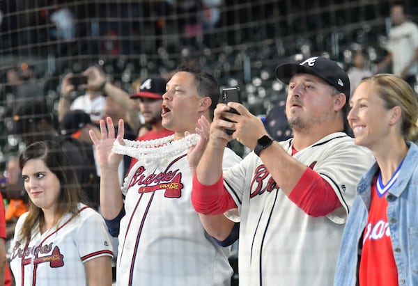 Atlanta Braves fans cheer as Atlanta Braves players work out on the field Wednesday prior to Game 2 of baseball's World Series at Minute Maid Park in Houston. (Hyosub Shin / Hyosub.Shin@ajc.com)