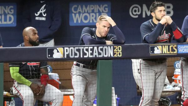 Braves Marcell Ozuna (from left), Freddie Freeman, and Travis d'Arnaud watch the final outs of Game 7 of the National League Championship Series against the Los Angeles Dodgers Sunday, Oct. 18, 2020, at Globe Life Field in Arlington, Texas. (Curtis Compton / Curtis.Compton@ajc.com)