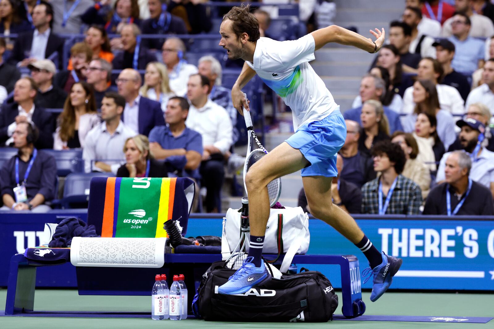 Daniil Medvedev, of Russia, leaps over the player's bench on a return against Jannik Sinner, of Italy, during the quarterfinals of the U.S. Open tennis championships, Wednesday, Sept. 4, 2024, in New York. (AP Photo/Adam Hunger)