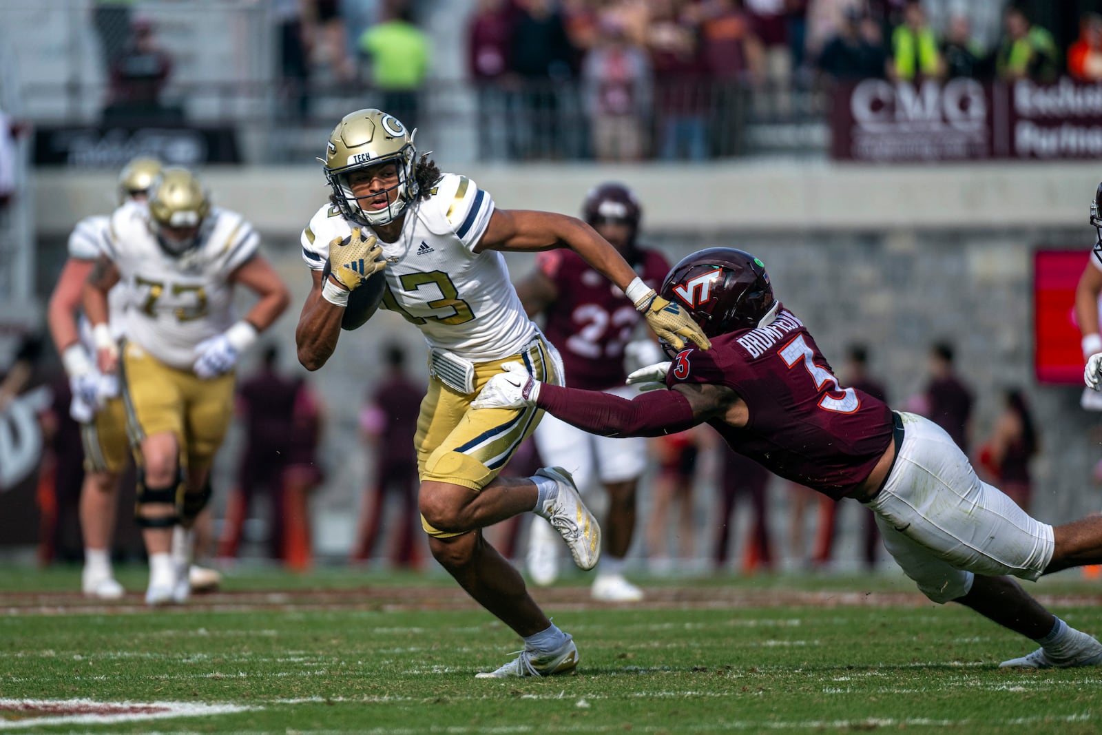 Georgia Tech's Isiah Canion gets by Virginia Tech's Sam Brumfield (3) during the second half of an NCAA college football game, Saturday, Oct. 26, 2024, in Blacksburg, Va. (AP Photo/Robert Simmons)