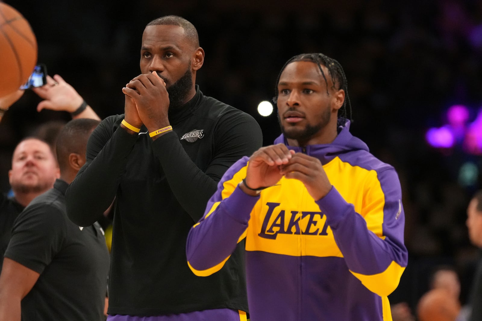 Los Angeles Lakers forward LeBron James, left, and guard Bronny James warm up before an NBA basketball game against the Minnesota Timberwolves, Tuesday, Oct. 22, 2024, in Los Angeles. (AP Photo/Eric Thayer)