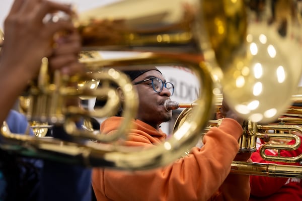 The Jonesboro High School marching band rehearses at the high school on Wednesday, Nov. 20, 2024. During rehearsal, there’s a buzz of excitement in the air for the upcoming trips to play in the Macy's Thanksgiving Day Parade in New York and the 2026 New Year's Day Parade in London. (Arvin Temkar/AJC)