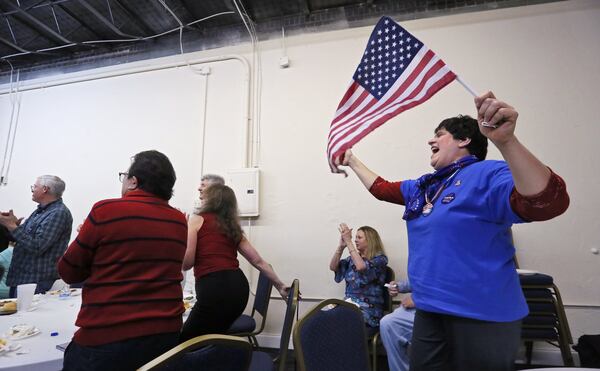 Theresa Sykes, who helped start a group called Team Trump Cobb Cobb County, cheers as Donald Trump appears at the televised ceremony. Republicans watched the Inauguration of Donald Trump at a party at GOP headquarters in Marietta. BOB ANDRES /BANDRES@AJC.COM