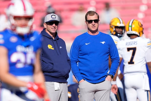 SMU head coach Rhett Lashlee, right, and California head coach Justin Wilcox chat on the field before an NCAA college football game Saturday, Nov. 30, 2024, in Dallas. (AP Photo/LM Otero)