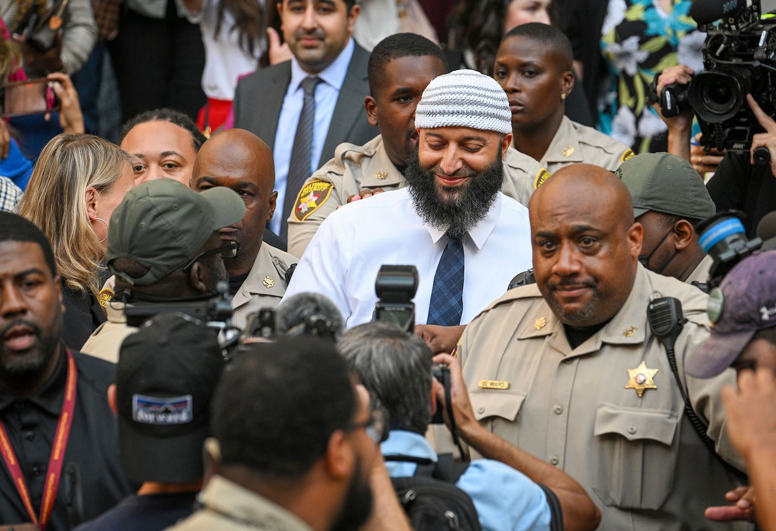 FILE - Adnan Syed, center, the man whose legal saga spawned the hit podcast "Serial," exits the Cummings Courthouse after a Baltimore judge overturned his conviction for the 1999 murder of high school student Hae Min Lee on Sept, 19, 2022, in Baltimore. (Jerry Jackson/The Baltimore Sun via AP, File)