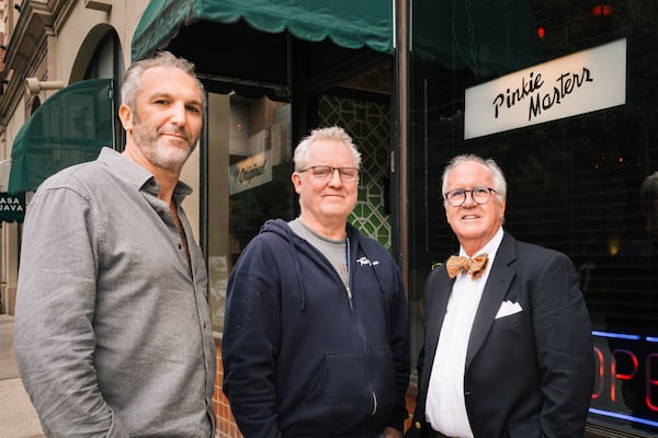 Co-owners Matt Garappolo and Mike Warren stand with Tommy Sullivan, a descendant of the original owner, in front of Pinkie Masters bar in Savannah, GA on December 23, 2024.  (Justin Taylor/The Atlanta Journal-Constitution)