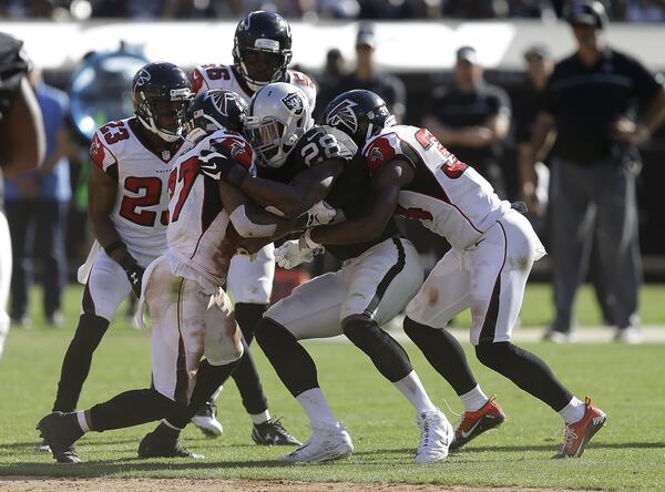 Oakland Raiders running back Latavius Murray (28) is tackled by Atlanta Falcons defenders during the second half of an NFL football game in Oakland, Calif., Sunday, Sept. 18, 2016. (AP Photo/Ben Margot)