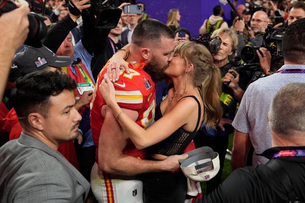 FILE - Kansas City Chiefs tight end Travis Kelce (87) kisses Taylor Swift after the Kansas City Chiefs defeated the San Francisco 49ers at the Super Bowl on Feb. 11, 2024, in Las Vegas. (AP Photo/John Locher, File)