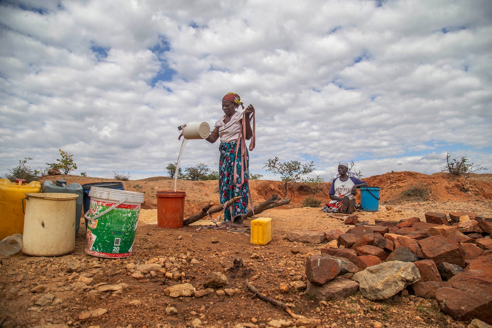 File — Villagers fetch water from a makeshift borehole in Mudzi, Zimbabwe, Tuesday, July 2, 2024. as the United Nations' food agency says months of drought in southern Africa, triggered by the El Nino weather phenomenon, has had a devastating impact on more than 27 million people and caused the region's worst hunger crisis in decades. (AP Photo/Aaron Ufumeli/File)