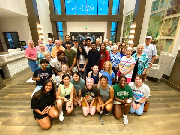 A group gathers in a common area at The Spires for a student/resident game night hosting Gates Scholars from Berry College. (Courtesy of The Spires and Berry College)