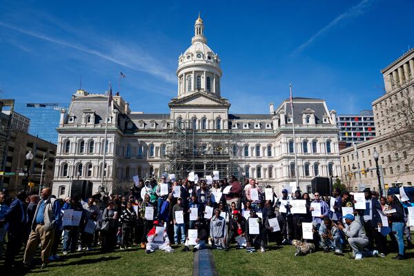 Survivors and advocates gather in front of Baltimore City Hall as civil rights attorney Kristen Feden speaks during a press conference, Wednesday, March 19, 2025, in Baltimore. (AP Photo/Stephanie Scarbrough)