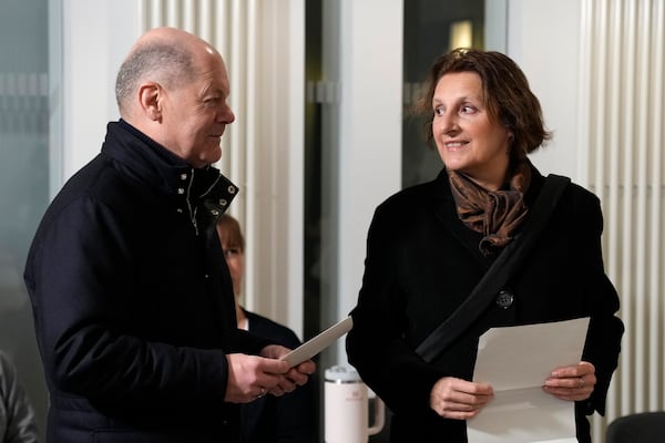 German Chancellor Olaf Scholz arrives with his wife Britta Ernst to cast their vote at a polling station in Berlin, Germany, Sunday, Feb. 23, 2025, during the German national election. (AP Photo/Ebrahim Noroozi)