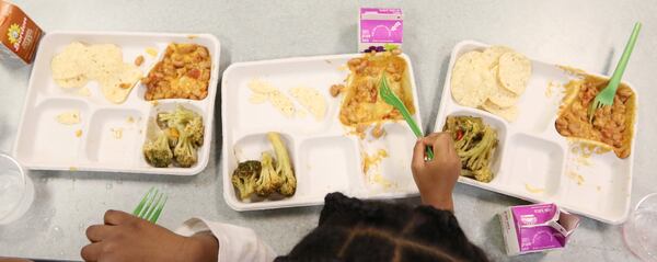 Students use biodegradable lunch trays and forks at Burgess-Peterson Academy in Atlanta on Friday. To celebrate Earth Day, Burgess-Peterson Academy is one of about 15 Atlanta schools that used biodegradable products, such as trays and forks. EMILY HANEY / emily.haney@ajc.com