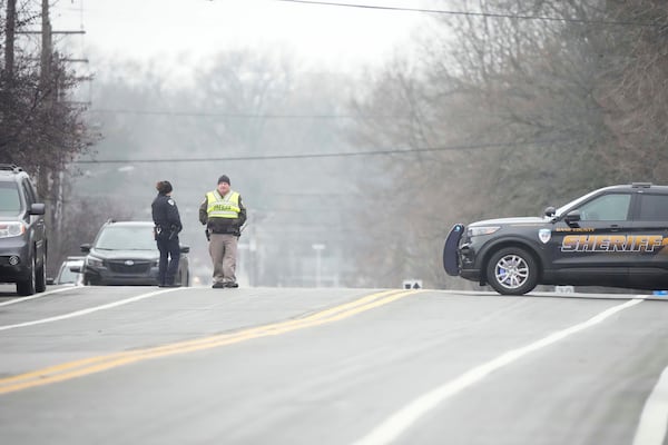 Police guard as emergency vehicles are parked outside the Abundant Life Christian School in Madison, Wis., where multiple injuries were reported following a shooting, Monday, Dec. 16, 2024. (AP Photo/Morry Gash)