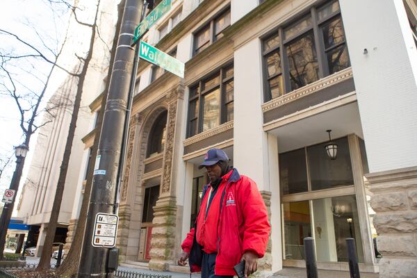 Seneca Langston walks in front of the Grant Building on Saturday, March 18, 2023, in Downtown Atlanta. Many office buildings like the Grant Building are being considered for apartment conversion since the pandemic has changed the office building landscape. CHRISTINA MATACOTTA FOR THE ATLANTA JOURNAL-CONSTITUTION