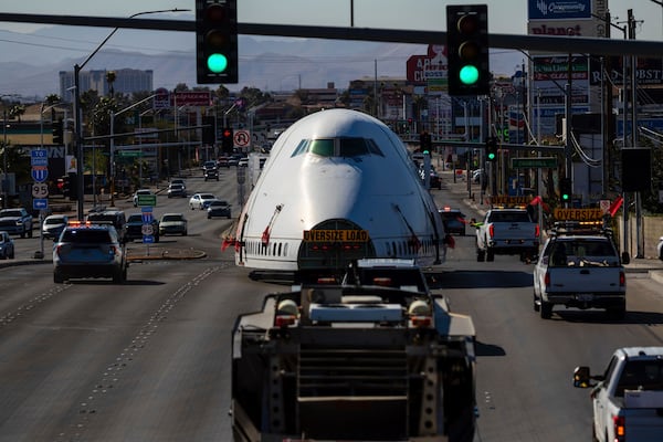 A section of a 747 airplane moves through Las Vegas streets on the way to a new home at Area 15 where it will be part of an immersive art display, on Wednesday, Feb. 26, 2025. (AP Photo/Ty ONeil)