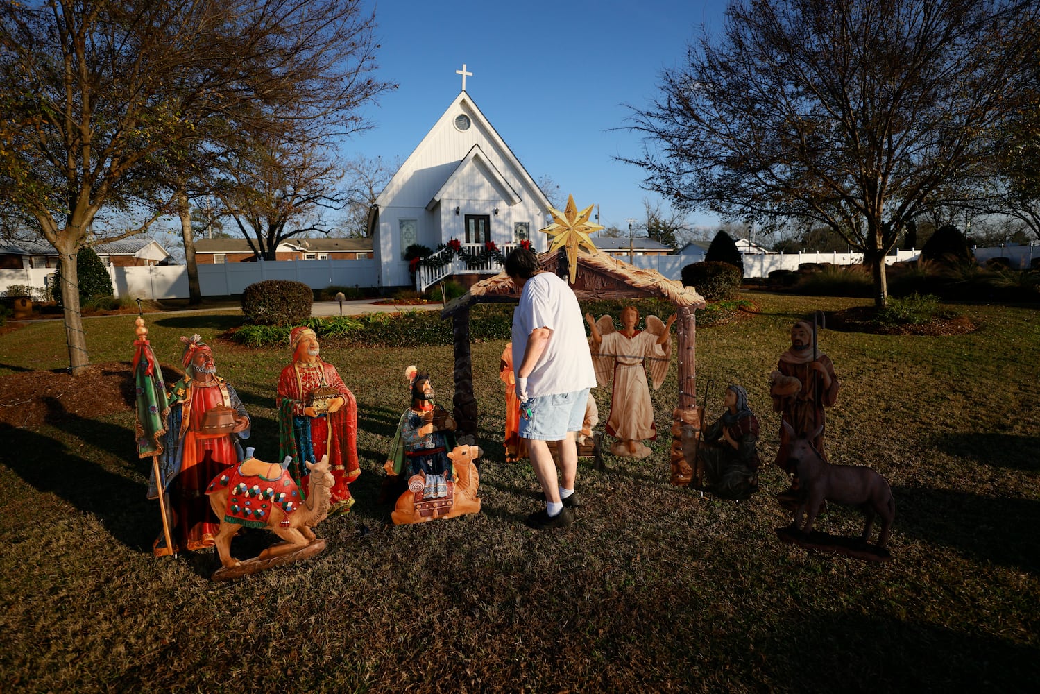 Santa Claus City mayor Donita Bowens works putting together a nativity scene located inside Santa’s garden in front of the chapel.
 Miguel Martinez / miguel.martinezjimenez@ajc.com