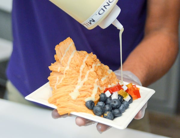 SnowVille Shavery has colorful options. Here, it’s Thai tea shave ice with toppings. CONTRIBUTED BY HENRI HOLLIS