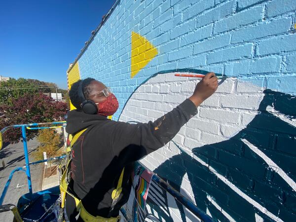 Atlanta artist Jasmine Nicole Williams works on a mural ornamenting the Plaza on Ponce as part of the collaboration between Living Walls and Adult Swim, The Adult Swim Atlanta Mural Project.
Courtesy of Joey Wathen