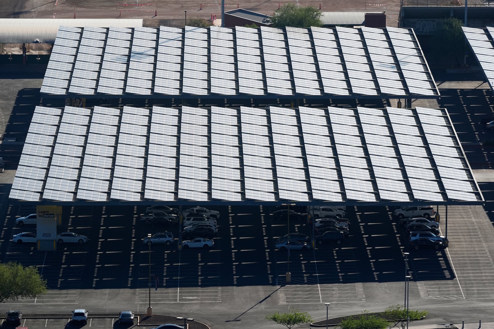 A surface parking lot is covered by solar panels at Arizona State University Tuesday, Sept. 24, 2024, in Tempe, Ariz. (AP Photo/Ross D. Franklin)