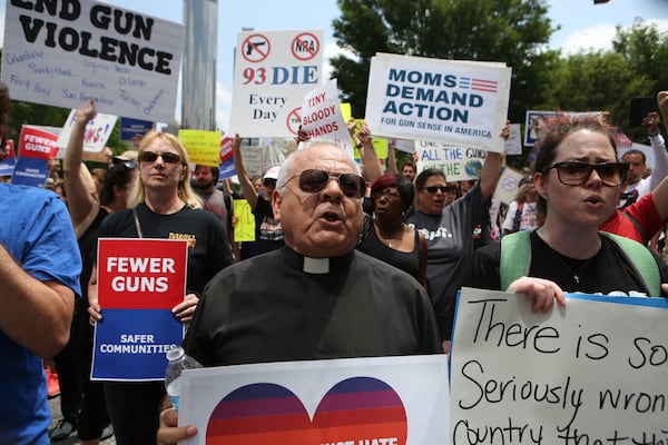 Protesters rally outside the NRA convention in Atlanta in 2017 before then-President Donald Trump was supposed to speak to the group. Democrats are grappling with how to respond to Trump now that he's returning to the White House. Henry Taylor/AJC 2017