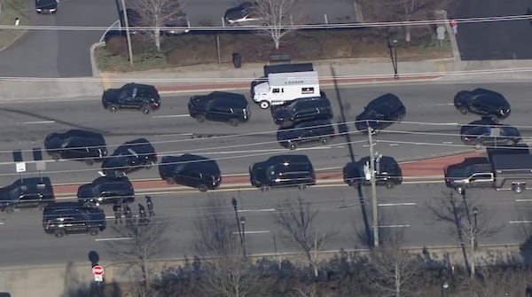 A Loomis truck is surrounded by Smyrna police vehicles on Spring Road. 