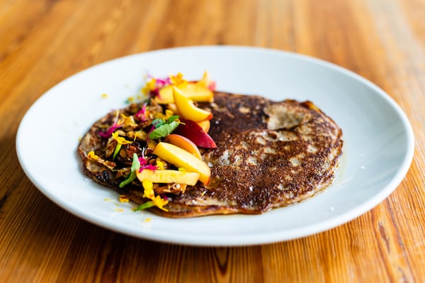 A peach pancake with marigold-maple syrup and almond brittle is one way to enjoy brunch at 8Arm. CONTRIBUTED BY HENRI HOLLIS