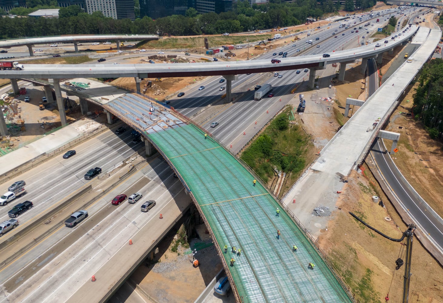 May 27, 2021 Sandy Springs - Aerial photo shows construction site of I-285 interchange at Ga. 400 in Sandy Springs on Tuesday, May 27, 2021. This view shows I-285 looking toward the east. Cutting across the top of the photo is the new I-285 ramp Eastbound from Georgia 400. (Hyosub Shin / Hyosub.Shin@ajc.com)