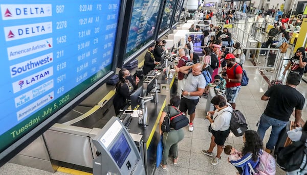 July 5, 2022 Hartsfield-Jackson International Airport: Airline travelers lined up at the ticket counter on the North Terminal at Hartsfield-Jackson International Airport on Tuesday, July 5, 2022. (John Spink / John.Spink@ajc.com)