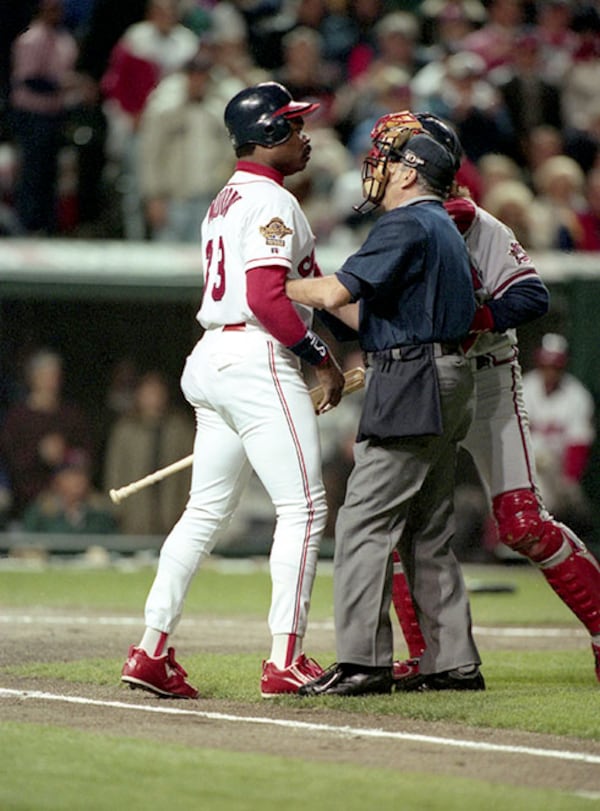 Cleveland's Eddie Murray (left) is restrained by the umpire and Braves catcher Charlie O'Brien (right) after burshback pitch from Atlanta's Greg Maddux in Game 5 of the 1995 World Series, Oct. 26, 1995, in Cleveland. (Frank Neimeir/AJC)